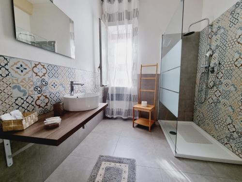 a bathroom with a sink and a shower at Enne's Apartments in the heart of Palermo in Palermo