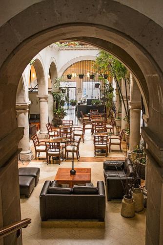 a room with tables and chairs in a building at Hostal de La Monja in Durango