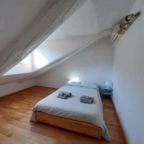 a bedroom with a bed with two pillows on it at Casa Breton in Turin