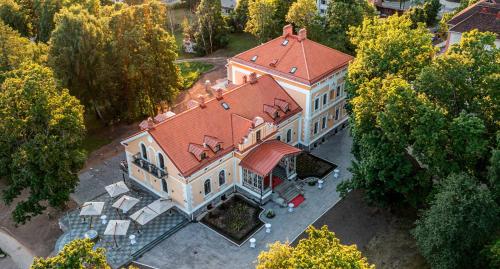 einen Blick über ein großes Haus mit rotem Dach in der Unterkunft Schloss Fellin Boutique Hotel and Spa in Viljandi