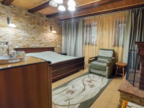 a bedroom with a bed and a chair in it at Elf-cottage in Tur'ya Pasika