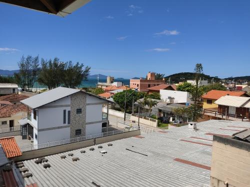 a view of a town with a white building at Pousada Massiambu in Palhoça