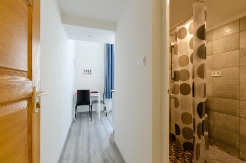 Un pasillo con una mesa y sillas en una habitación. en Bartok Suites, en Budapest