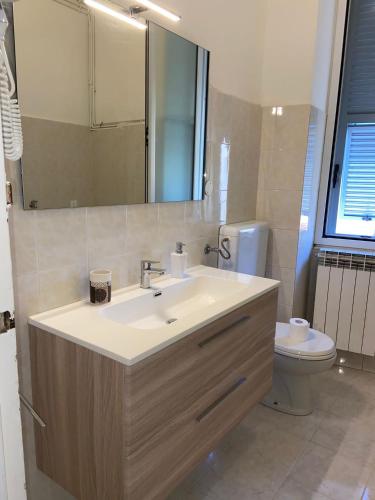 a bathroom with a sink and a toilet at Appartamenti Fiore in Sanremo