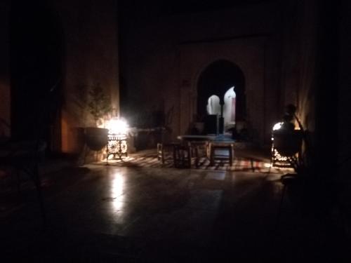 a dark room with a light in the middle at Riad Amar in Merzouga