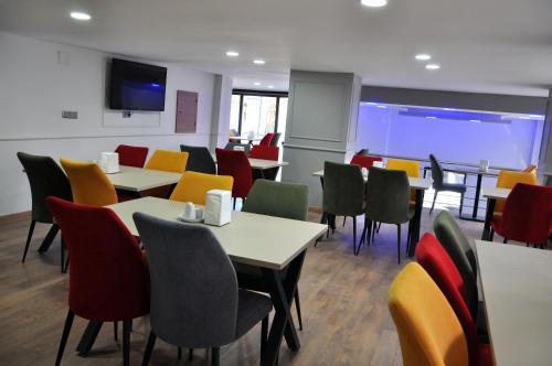 a dining room with tables and colorful chairs at SAKA LİFE OTEL in Erzurum