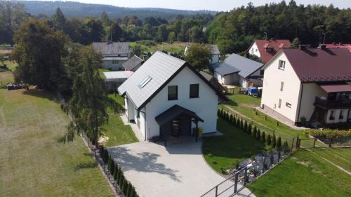 an aerial view of a village with a white house at Krasnobród Dom Całoroczny in Krasnobród