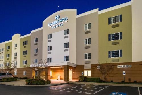 an exterior view of a hotel at night at Candlewood Suites Paducah by IHG in Paducah