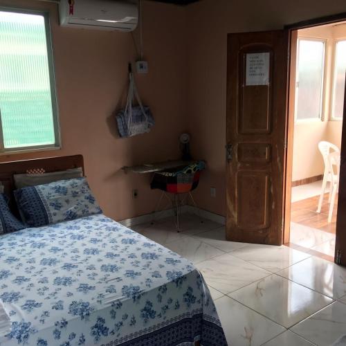 1 dormitorio con 1 cama con edredón azul y blanco en Apartamento Suíte em Soure., en Soure