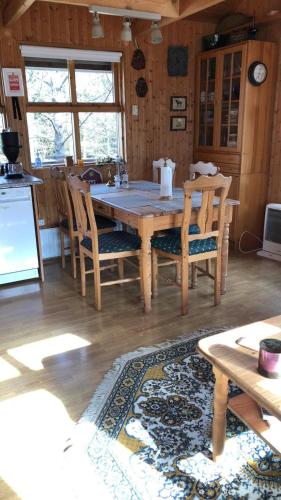 a kitchen with a table and chairs in a room at The Golden Circle Cabin in Selfoss