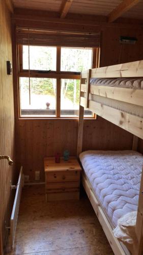 a bedroom with two bunk beds and a window at The Golden Circle Cabin in Selfoss