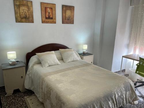 A bed or beds in a room at APARTAMENTO TURISTICO MILLAN