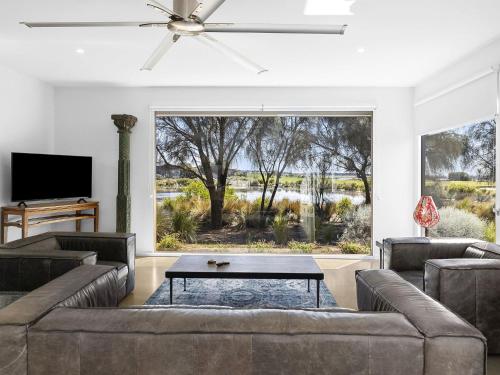 a living room with two couches and a large window at Lahinch Beach House 32 in Torquay