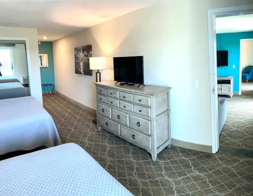 a bedroom with a dresser with a television on it at Riverview Resort in South Yarmouth