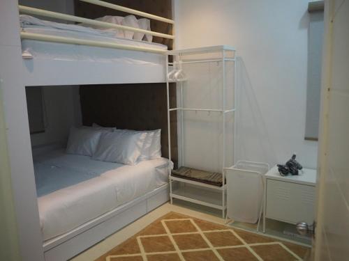 a bedroom with a white bunk bed with a closet at Terengganu Guest House 2 in Marang