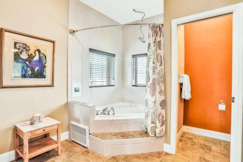 a large bathroom with a tub and a shower at Sea Turtle Manor in New Smyrna Beach