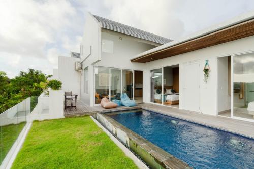 a swimming pool in the backyard of a house at Aurelia Residence in Uluwatu