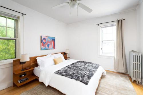a white bedroom with a bed and a ceiling fan at Flexhome Economy 2BR Apartment B2 - READ INFO in Milwaukee