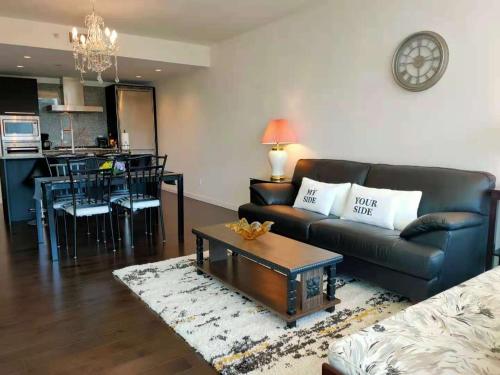 a living room with a couch and a table at WaterFalls Hotel - Suite in Falls Downtown with pool in Victoria