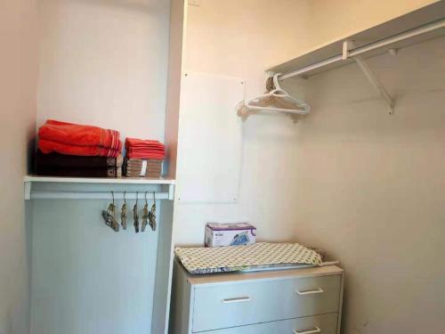 a closet with a door and a shelf with towels at Relaxing condo in Falls Downtown Victoria in Victoria