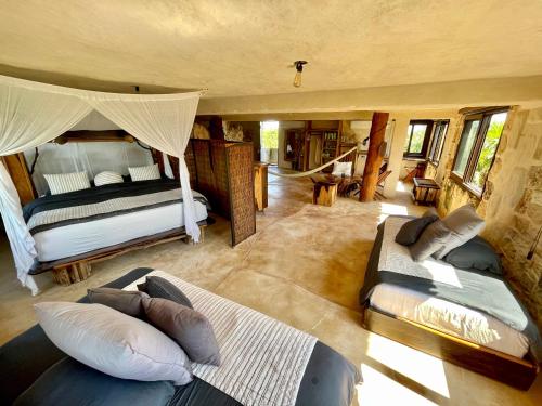 a large room with two beds and a living room at Sueños Tulum in Tulum
