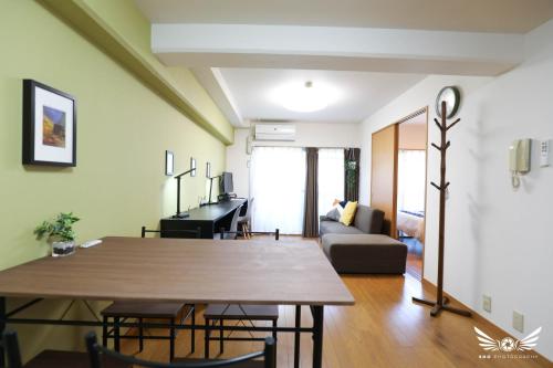 a living room with a table and a couch at Minoshima Apartment 402 in Fukuoka