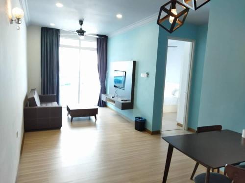 a living room with a couch and a table at ExcluSuites Malacca @ The Wave Residence in Melaka