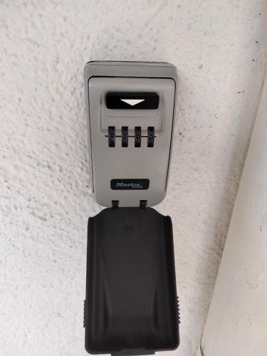 a security device is attached to a wall at Chez Papinette, proche gare et centre, pdj compris in Niort