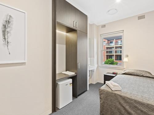 a bedroom with a bed and a window at Padstow Park Hotel in Padstow