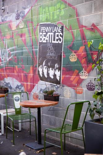 a table and chairs in front of a wall at Padstow Park Hotel in Padstow