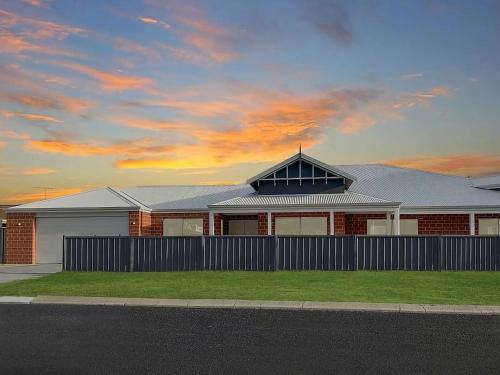 a house with a fence in front of it at Tranquil Waters in Busselton