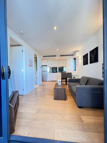 a living room with a couch and a table at Flinders Street Apartments in Melbourne