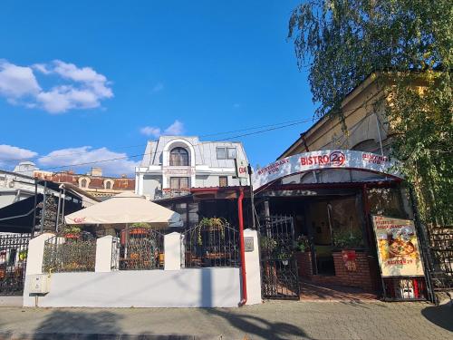 a building with an umbrella next to a street at Bistro 29 in Ploieşti