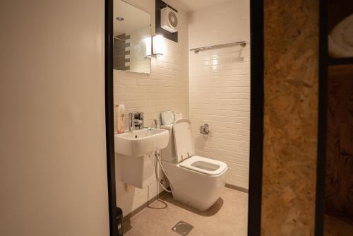 a bathroom with a toilet and a sink at Bear Grylls Explorers Camp in Ras al Khaimah