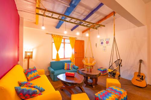 a living room with a swing couch and a table at goSTOPS Nainital in Nainital