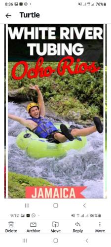 a woman is rafting on a river on a website at Towers by the Beach in Ocho Rios