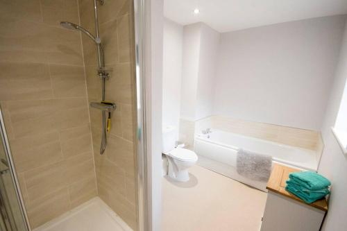 a bathroom with a shower and a toilet and a sink at Entire Duplex apartment for up to 6 guests, free wifi in Darlington