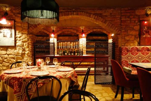 a dining room with a table and a wine cellar at Hotel Memoire Kutaisi in Kutaisi