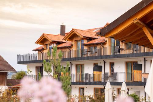 a building with tile roofs and a fence at Danner-Hof in Kochel