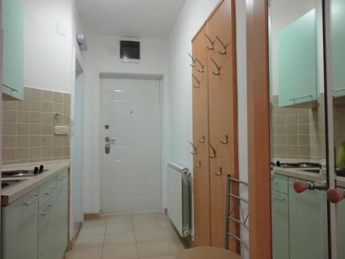 a kitchen with a door leading to a bathroom at Accommodation Mell in Ohrid