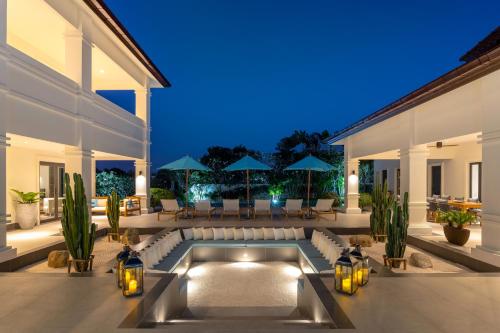 a swimming pool in the middle of a house at Luxury 5 Bedroom Pool Villa B11B in Hua Hin