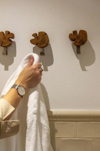 a woman is holding a towel on a wall at Gut Moorbeck in Amelhausen