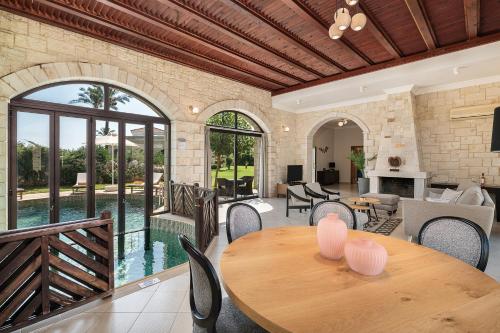 an open living room with a table and chairs at Caldera Platanias Villas in Plataniás