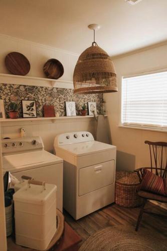 a kitchen with a stove and a washing machine at The Woodlawn Guest Cottage in Hot Springs
