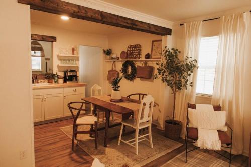 a kitchen with a dining room table and chairs at The Woodlawn Guest Cottage in Hot Springs