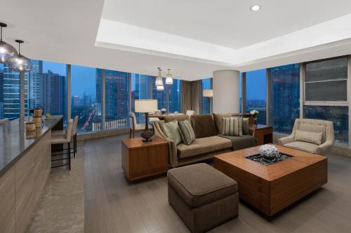 a living room with a couch and a table at Ascott IFC Guangzhou - Free Shuttle Bus For Canton Fair in Guangzhou