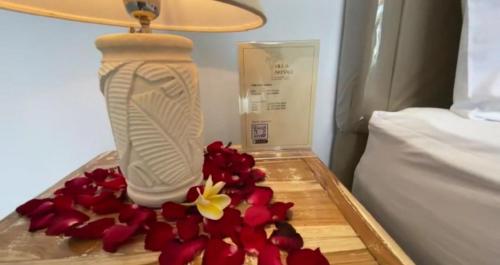 a tray with flowers and a lamp on a bed at Villa Akmali Canggu - 2 Bedrooms in Canggu
