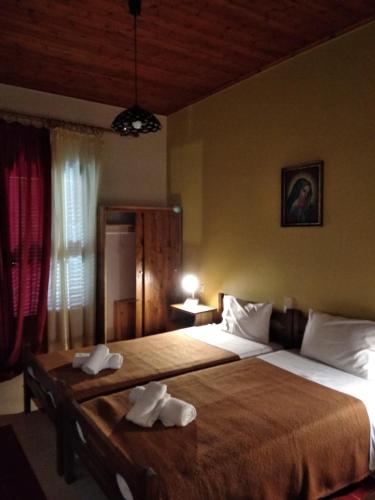 Ένα ή περισσότερα κρεβάτια σε δωμάτιο στο Elatos Rooms
