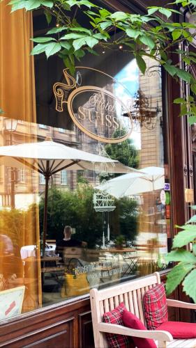 a shop window with a bench in front of a store at Hotel Suisse in Strasbourg