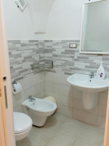 a bathroom with a toilet and a sink at BED&BREAD Piazza 'Nzegna in Carovigno